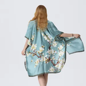 Light blue floral kimono beach cover-up detail, elegant magnolia print loose sun protection shawl.