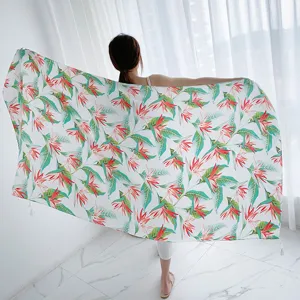 Detailed view of women's floral print cotton beach towel and summer travel sun protection shawl.