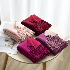 Close-up shot of double-sided solid color imitation cashmere scarves with fringe details.
