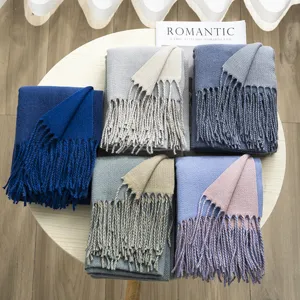 Detail view of winter solid color reversible imitation cashmere scarf with chic fringe details.
