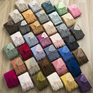 Detailed close-up view of multicolored cashmere feel tassel scarves, showing soft texture.
