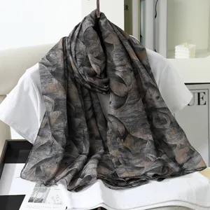 Detailed view of the stylish large faux silk scarf featuring an elegant floral print design.