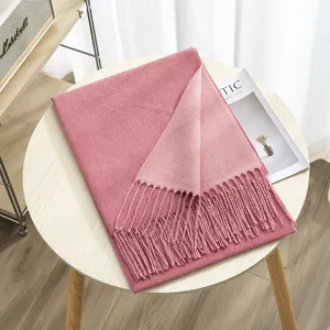 Detailed view of the winter reversible cashmere feel scarf with chic fringe, cozy pink shawl.