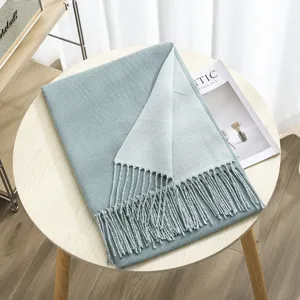 Two-tone cashmere-feel winter scarf with delicate fringes, soft and warm accessory detail.