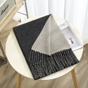 Detailed view of two-tone reversible cashmere-feel winter scarf with fringe design.