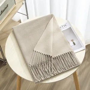 Detailed view of cozy thickened double-sided solid color fringed cashmere-feel scarf in beige.