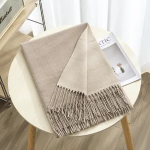 Detailed view of winter women double-sided cashmere-feel scarf with elegant fringe and warmth.