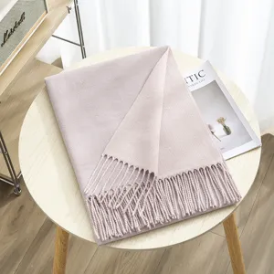 Double-sided solid color imitation cashmere scarf detail showing soft warm tassel design.