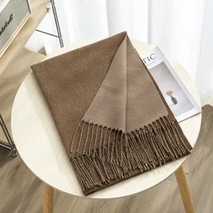 Close-up detail of the soft double-sided cashmere-feel winter scarf with elegant tassels.