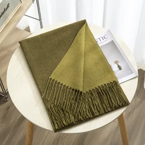 Detailed close-up showing the soft texture and fringe details of the warm winter scarf.