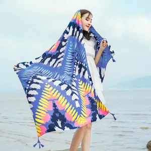 Ethnic style long beach towel scarf with tassels, perfect breathable wrap for summer vacation travel.