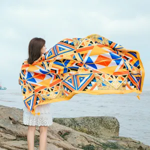 Detailed view of the vibrant geometric beach towel scarf, outdoor coastal style display.