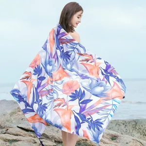 Detailed view of the tropical floral beach scarf featuring vibrant print and lightweight drape.