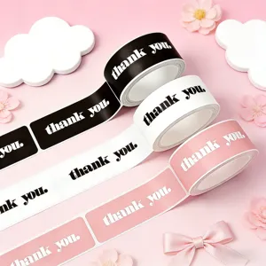 Detail shot of minimalist thank you rectangular sticker rolls in pink, black and white.