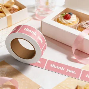 Close-up detail of pink thank you sticker roll, perfect for minimalist dessert packaging.
