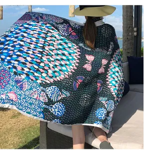 Close-up detail of a colorful retro geometric patterned shawl scarf with butterfly design.