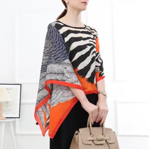 Detailed view of the stylish imitation silk sun protection shawl with zebra and feather print.
