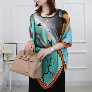 Detailed view of a stylish imitation silk poncho cape featuring elegant crane and landscape print.