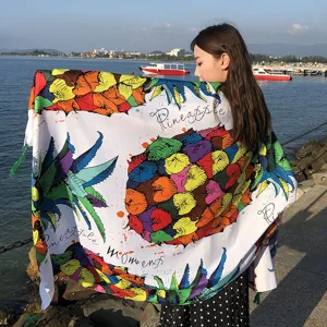 Detailed view of colorful pineapple print beach scarf outdoors, retro style linen shawl.