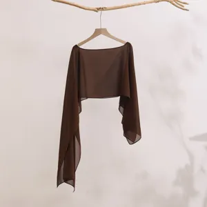 Close-up detail of a brown sheer long sleeve sun protection shrug cardigan hanging nicely.