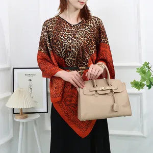Detail view of women's silk-like cape top with leopard and paisley print, stylish summer wear.