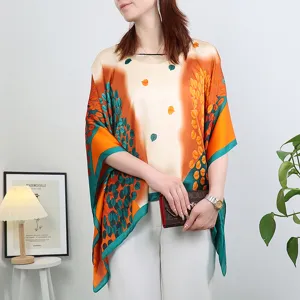 Silk sun protection shawl detail view, abstract leaf print poncho for summer outfit.