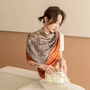 Elegant 110cm square silk scarf for women, featuring a split black, white and orange luxury print.