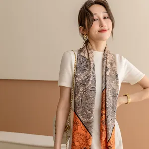 Elegant women silk scarf featuring artistic jungle pattern in orange and black tones for daily wear.