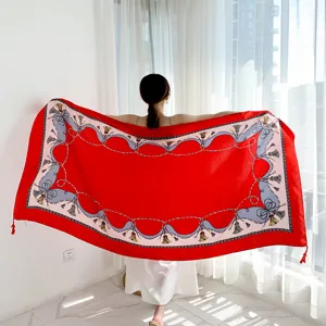 Red silk scarf with elegant chain and tassel print, perfect for summer sun protection.
