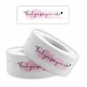 Detailed view of pink watercolor thank you stickers roll, ideal for envelope sealing and gifts.