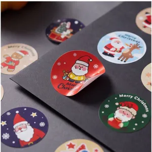 Detailed view of colorful Christmas round sealing stickers with cute Santa and reindeer patterns.