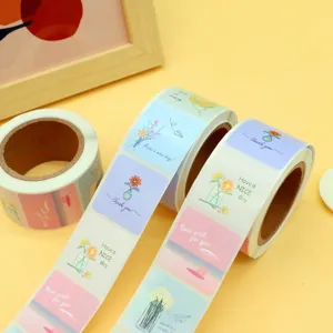 Detail view of decorative adhesive sticker rolls featuring floral and scenic designs with text.