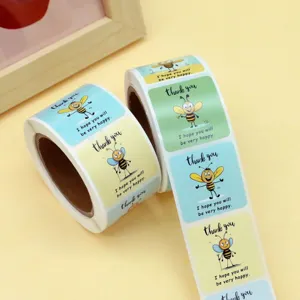 Close up detail view of roll adhesive stickers featuring cute cartoon bees and thank you text.