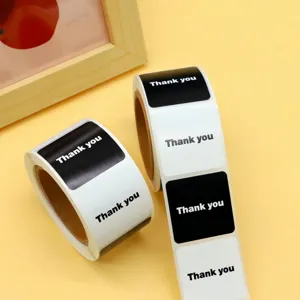 Close-up detail of black and white thank you stickers rolls, perfect for handmade craft packaging.