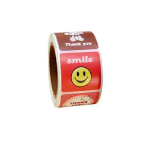 Roll of cute thank you stickers with smiling face and dog design, perfect for baking and gifts.