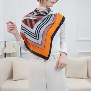 Detailed view of women's colorful geometric silk square scarf, elegant geometric print.