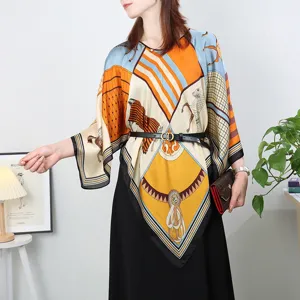Detail view of the silk scarf poncho with geometric equestrian print style for summer.