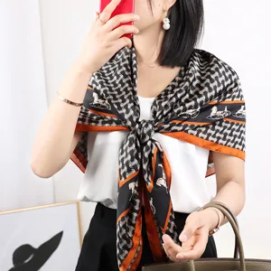Elegant black and white square silk scarf with luxury carriage print and chic orange border.