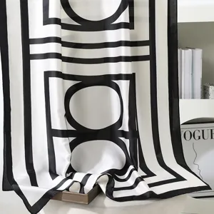 Dettaglio foulard in seta nero e bianco con motivo geometrico e bellissima texture.