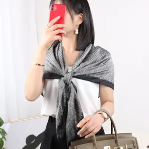Black and white silk square scarf detail, elegant floral pattern, stylish neckerchief for women.