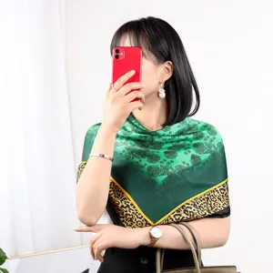 Elegant green silk square scarf with floral print and leopard border for women styling accessories.