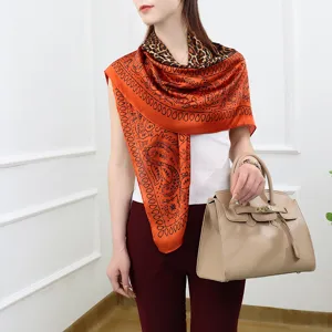 Orange silk-feel square scarf with paisley and leopard print for women, elegant fashion accessory.