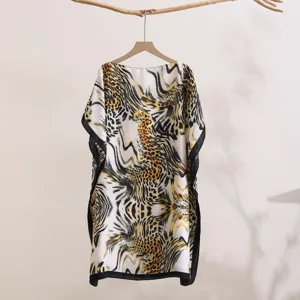 Women abstract print sun protection shawl detail, loose off-shoulder summer cover-up.