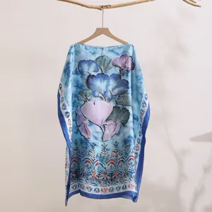 Close-up details of the blue printed botanical pattern on the elegant lightweight sun protection shawl.
