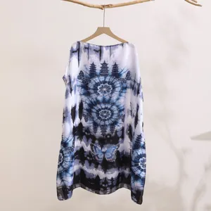 Detail of blue white tie-dye sun protection clothing with pagoda and butterfly print.