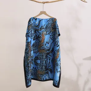 Close-up detail view of blue leopard print silky sun protection shawl, lightweight.