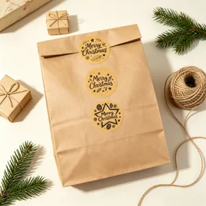 Vintage kraft paper Christmas round sealing stickers detail shot with festive holiday prints.