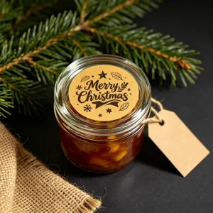 Christmas glass jar detail shot with vintage kraft paper label and pine branch decoration.