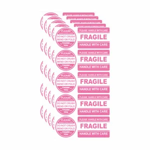 Pink fragile warning stickers details showing adhesive labels for shipping, mailing, and envelopes.