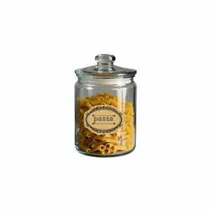 Detail view of a clear glass storage jar filled with penne pasta and decorative label.
